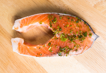 Raw Salmon steak  on cutting boardの写真素材