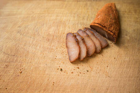 raw smoked horse meat Basturma traditional Armenian cuisine tasty dish wooden cutting board background textured surface concept food photography, copy spaceの写真素材