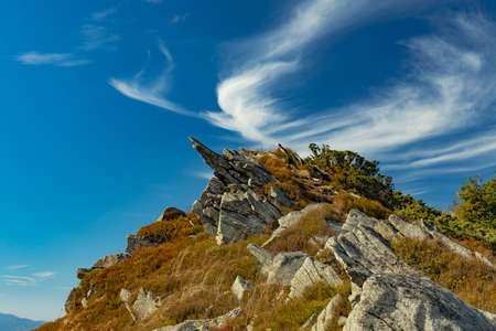 picturesque rocky mountains north European nature scenery landscape wallpaper view with beautiful vivid blue sky and cloudscapeの写真素材