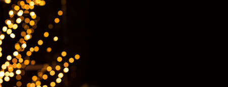 blurred unfocused golden bokeh illumination frame effect on black background wallpaper pattern picture with empty copy space for your text, Christmas lighting and winter holidays conceptの写真素材