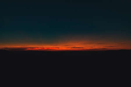 abstract horizon sunset twilight lighting dark blue and orange color unfocused surreal natural background wallpaper pattern photography with empty copy space for your textの写真素材