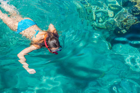 teenage girl enjoy by swimming and snorkeling in Red sea clean water in summer vacation time summer season relaxation background wallpaper picture with empty copy spaceの写真素材