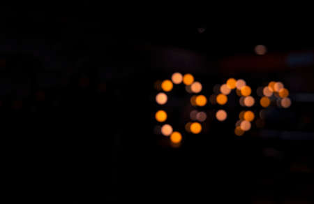 abstract black background pattern with unfocused glowing yellow circles and empty copy space for your text hereの写真素材