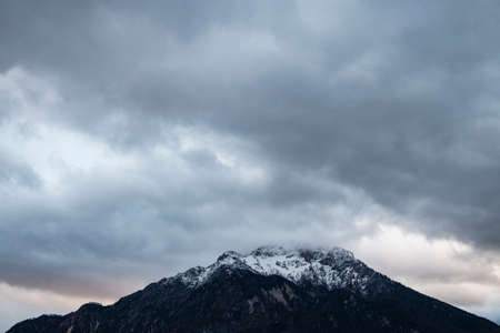 winter time snowy mountain peak highland dramatic landscape photography moody cloudy sky background, gorgeous nature wallpaper empty copy space for your textの写真素材