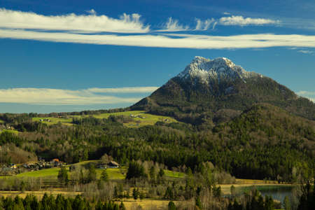 European village in Austrian Alps rural country side houses in spring time season green trees and...