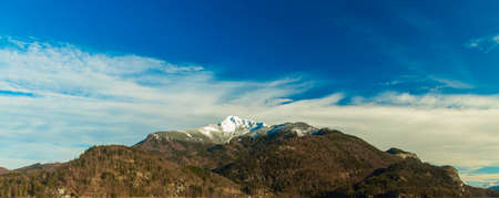 gorgeous picturesque mountain ridge with snowy peak highland scenery landscape background view blue sky white clouds in clear weather day time, wallpaper pattern nature concept copy space for textの写真素材