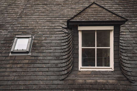 old gray shingle roof white window frame background of medieval European north architecture building in Stockholm Sweden entourage urban styleの写真素材
