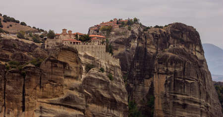 Christian highland monastery pilgrimage religion destination for believer people in Greece gorgeous rocky mountain wilderness scenic landscape environment in cloudy moody weatherの写真素材