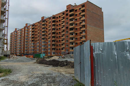 construction building fenced territory in gray depressed dayの写真素材