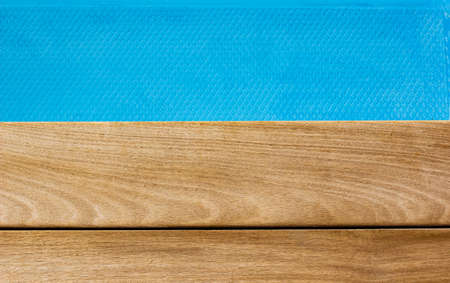 simple background textured wallpaper pattern picture brown wooden deck floor and swimming pool blue water smooth surface horizon board, empty space for copy or textの写真素材