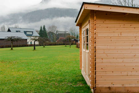 warehouse wooden cabin outskirts of European village landmark place in spring time cloudy rainy weatherの写真素材