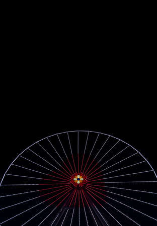 Saint Valentine holidays carnival festive Ferris wheel with heart shape illumination at night on black background empty copy space for your text here, vertical pictureの写真素材