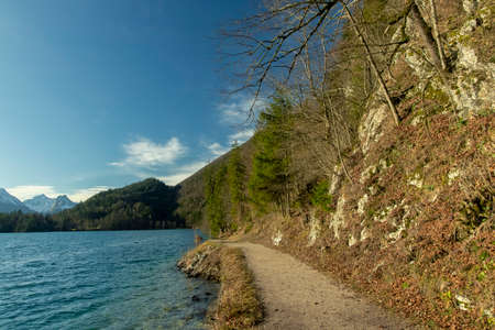 majestic peaceful landscape early spring time March month scenic view environment dirt trail along lake waterfront under mountain hill beautiful placeの写真素材