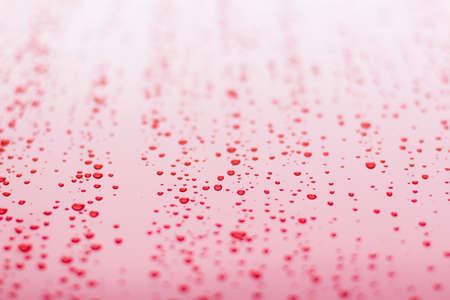 water drops on white red smooth metallic perspective textured background surface simple pattern pictureの写真素材