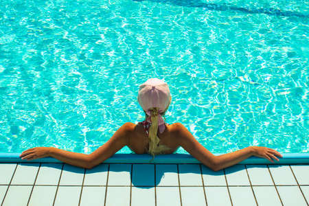 woman relaxation in swimming pool of some south resort, copy spaceの写真素材