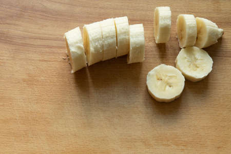 morning breakfast food cut banana fruit wooden cutting board background textured copy spaceの写真素材