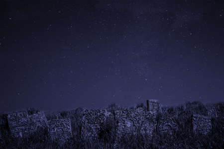 night mystery cemetery gravestones Halloween concept atmospheric scary photography with blue star...