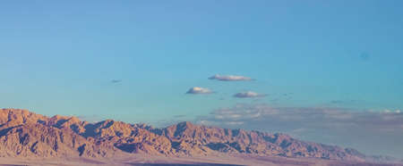 desert perspective mountain range landscape gorgeous scenic view in sunset orange lighting and blue sky background wallpaper nature photography empty copy space for your textの写真素材