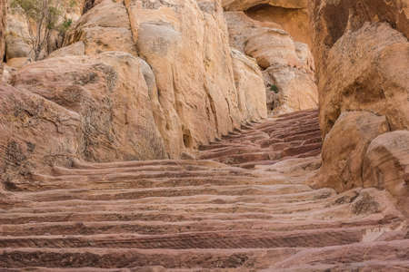 Middle East holy land sand stone desert canyon stairway passage between rocks religion pilgrimage destinationの写真素材