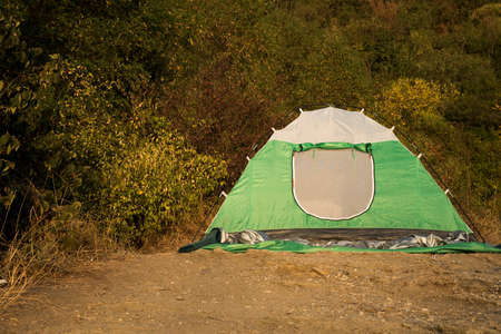 camp tent nature hiking life style passion object on forest green foliage outdoor environment backgroundの写真素材