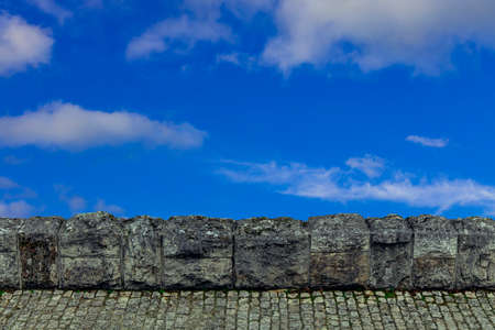 horizon simple background of gray stone material paved road and fence with vivid blue sky wallpaper pattern concept empty copy space for your textの写真素材