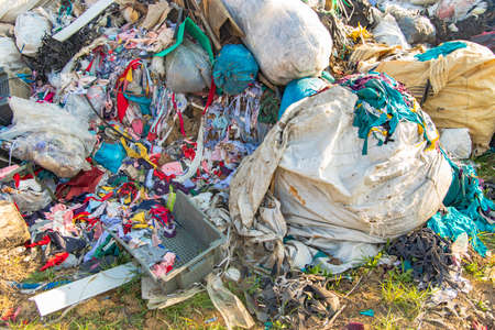 dump garbage background waste trash plastic and clothes global pollution ecological disaster conceptの写真素材