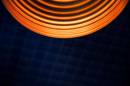 abstract interior roof view inside circle lamp geometry shape orange illumination and dark blue grid background copy space for your textの写真素材