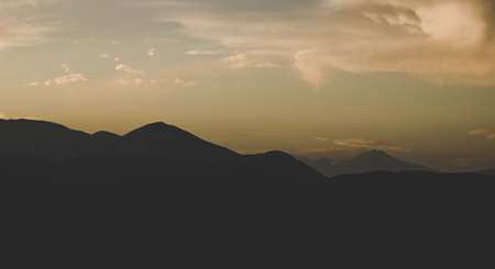 dark evening black mountain ridge silhouette shape nature landscape wallpaper background with copy space for your text hereの写真素材
