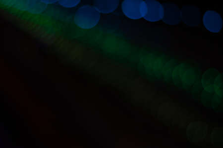 dark unfocused blue and green bokeh black background wallpaper pattern concept empty copy space for your textの写真素材