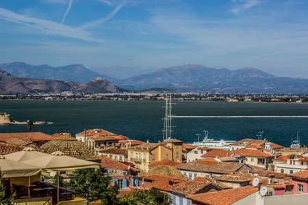 aerial photography of south European small medieval city in Mediterranean landscape district with sea bay harbor town and foggy mountain ridge background space silhouetteの写真素材