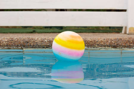 ball floating in water surface swimming pool side space outside yard in garden copy space for your text hereの写真素材