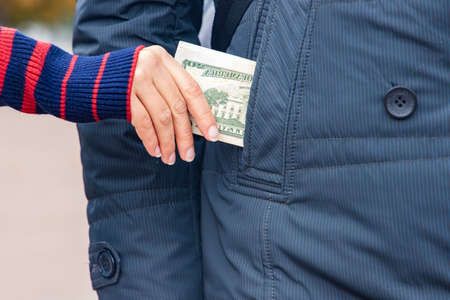 steal money from pocket theft process concept picture with female handの写真素材