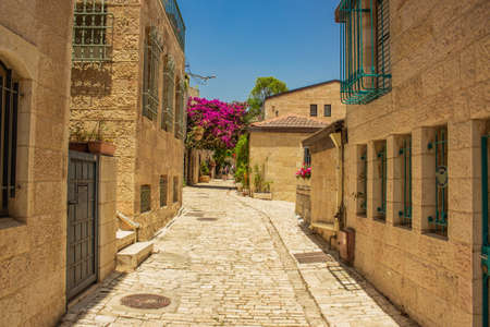 Jerusalem Israeli capital ancient city street stone paved walk side alley between living building in summer season bright sunny day timeの写真素材