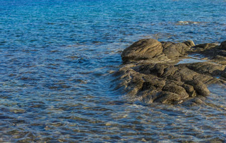 nature stone shore line scenic view with rocks and blue water wavy surface simple outside background spaceの写真素材