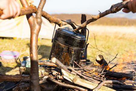 camping bowler on camp fire hiking life style concept picture in outdoor highland space outdoor environmentの写真素材