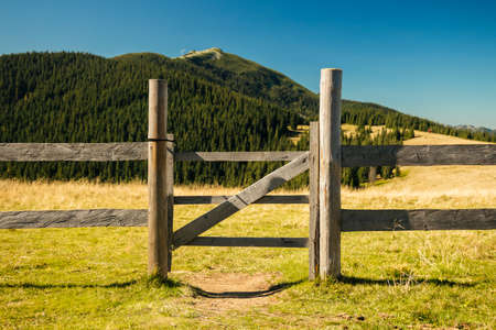 highland country side village fence and gate wood material landscaping object mountain scenic view background space outsideの写真素材