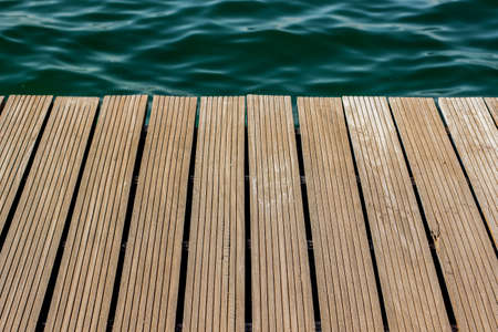wooden deck waterfront outdoor exterior floor perspective background texture and sea water surface wallpaper pattern with empty space for copy or your text hereの写真素材
