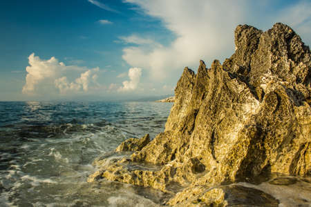 summer storm sea sand and rocky waterfront shoreline scenic landscape copy space for textの写真素材