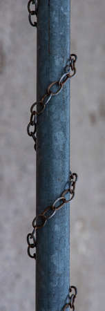 rustic industrial object iron pile and chain vertical picture blurred background space
