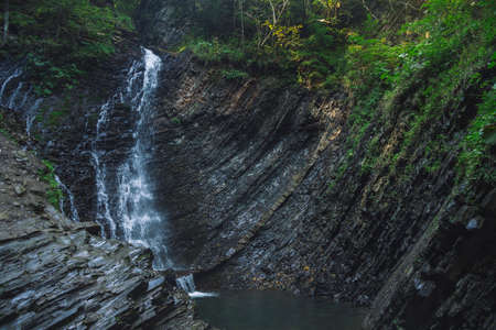 forest cascade waterfall cold rocky wood land scenic view with soft focus fuzzy water motion north...
