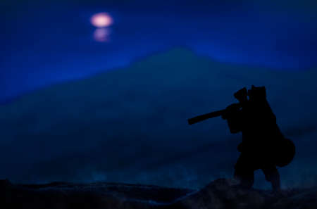 ancient warrior stranger vagabond person silhouette in fur cape with ax stay back to camera on a...