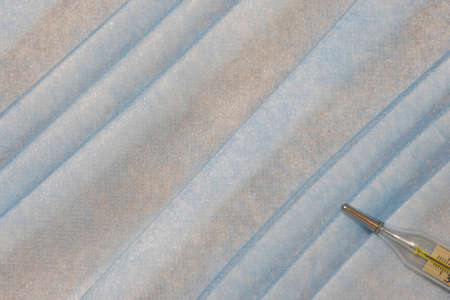 medical health care simple background of soft blue pastel color fabric texture and thermometer...