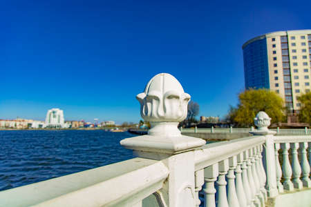 Europe city waterfront walking site district summer clear weather day time marble fence architecture element foreground and modern building background on river shore line districtの写真素材