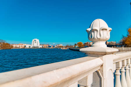 summer waterfront park district white marble fence architecture object foreground and river waters...