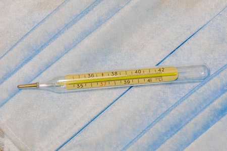 medical thermometer health care object on pastel textile cloth soft blue color fabric simple...