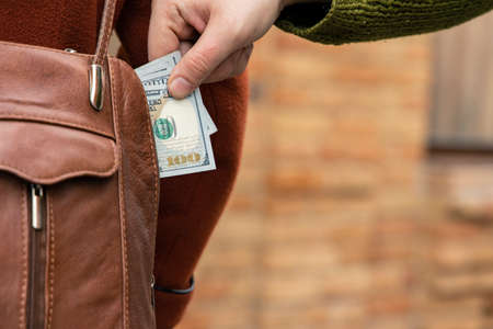 pick pocketing crime action try to steal money from female coat pocket on the street