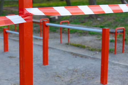 limited ban tape red and white color around sport playground area outside space unfocused backgroundの写真素材