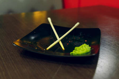 dusty plate after sushi rolls Asian kitchen restaurant table soft focus concept picture twilight lightingの写真素材