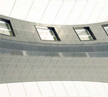 abstract architecture curved geometry lines exterior wall gray and white surface with windows...