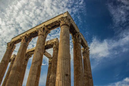 example of Greek architecture ancient columns ruins of old antique heritage temple shape on vivid blue sky background, empty copy space for your text hereの写真素材